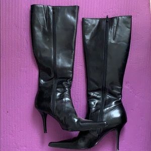 Black leather heeled knee-high boots